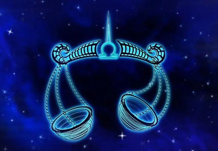 Neonowy symbol Wagi, 24 września znak zodiaku, lśni na tle nocnego nieba pełnego gwiazd.
