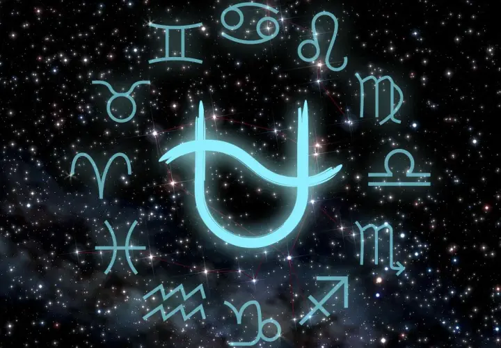 Jasnoniebieski symbol, być może nowy znak zodiaku, otoczony tradycyjnymi symbolami zodiaku na tle rozgwieżdżonego nieba.
