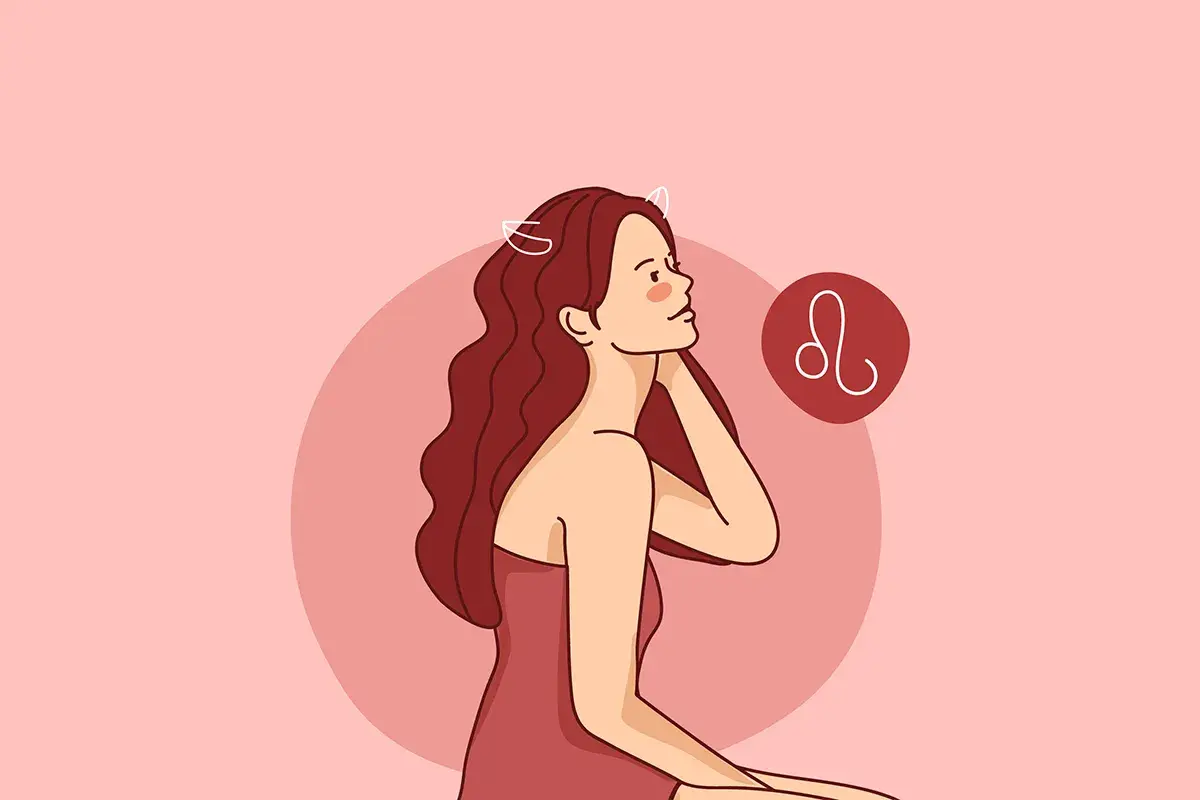 Kobieta lew z burzą rudych włosów i symbolem zodiaku.
